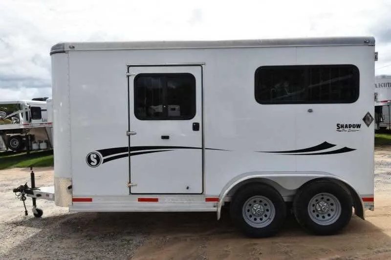 2016 Shadow 2 Horse Trailer – Aluminum, Dressing Room – Side view of the trailer showing the tandem axles and graphics