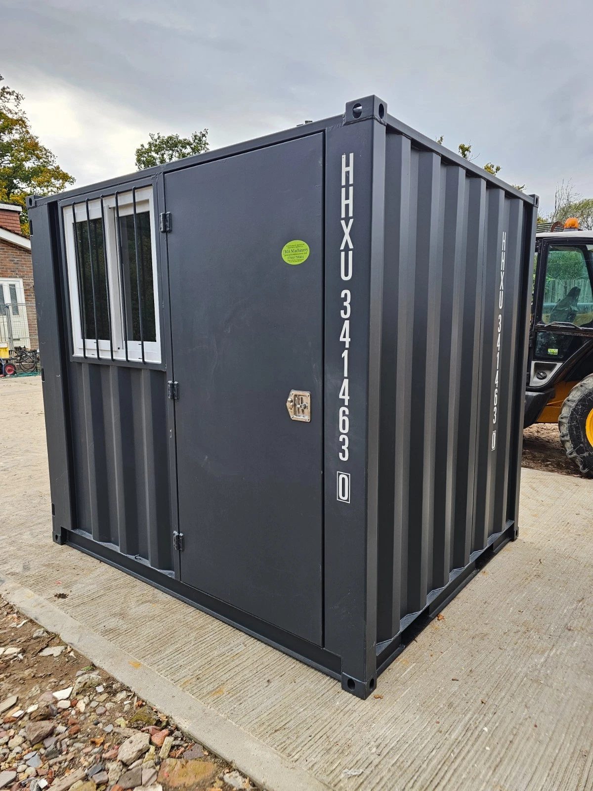 8ft New Shipping Container – Lockbox and Barred Windows – three-quarter exterior of storage unit with door and barred window