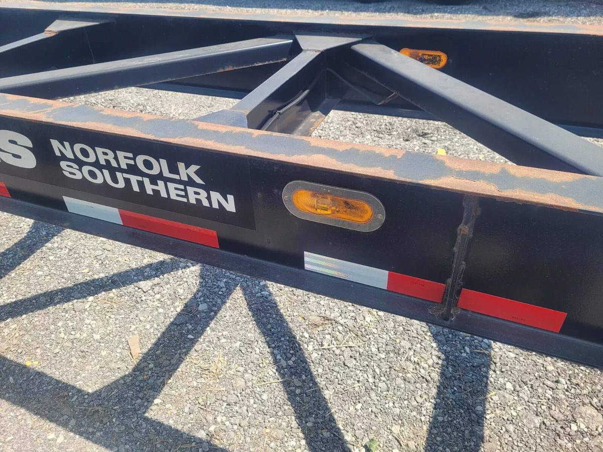 53ft Used Container Chassis – 2011, Spring Suspension – close-up of chassis frame with rust and side marker lights