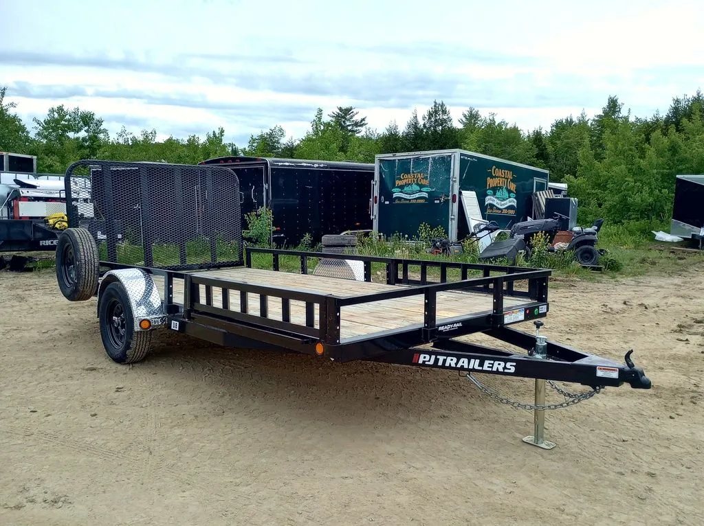 2024 PJ Trailers 14 ft Utility – Side Loading Ramps – Front three-quarter view of a black utility trailer with wooden floor and rails