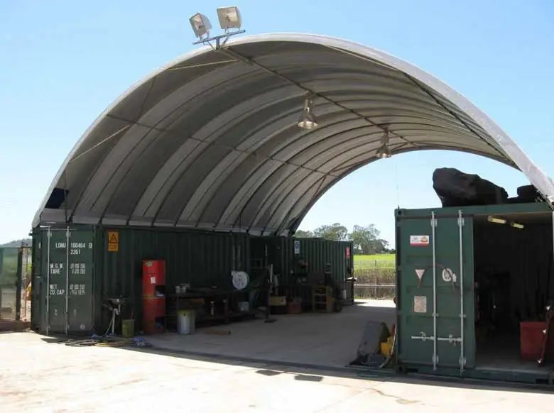 Container Shelter – Domed Tensile Membrane Cover – Inside a covered container shelter used as a workshop with green containers