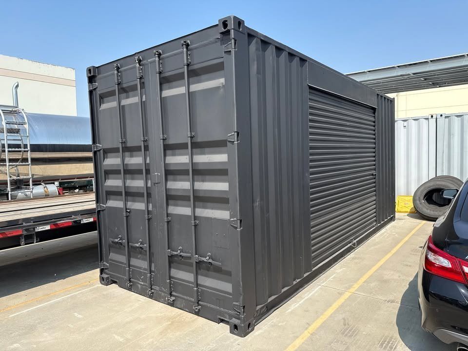 20ft Used Shipping Container – Matte Black, Side Roll-Up Door – three-quarter container exterior with closed cargo and side roll-up doors