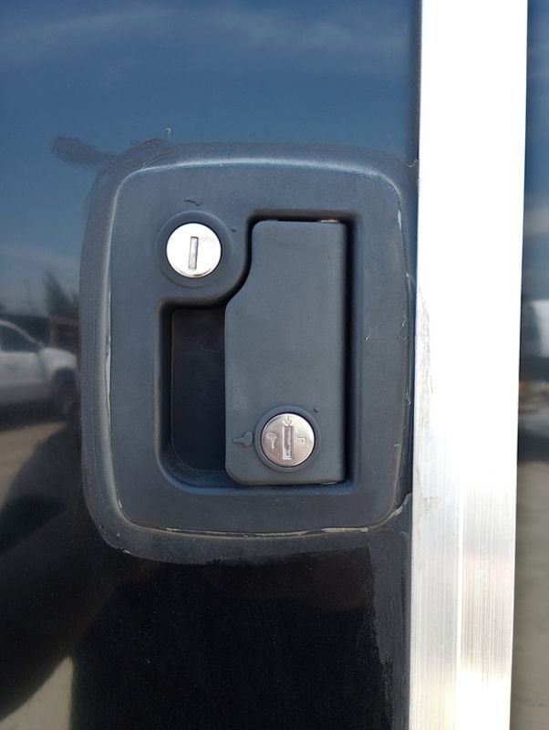 Mission Trailers 22 ft Snowmobile Trailer – 4-Place – Close-up of a black recessed door latch with two keyholes on the exterior