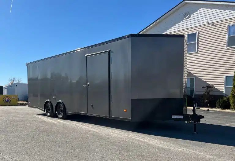 2025 Millennium 26 ft Car Hauler – Charcoal – Exterior side view showing the passenger side entry door and black-out package wheels