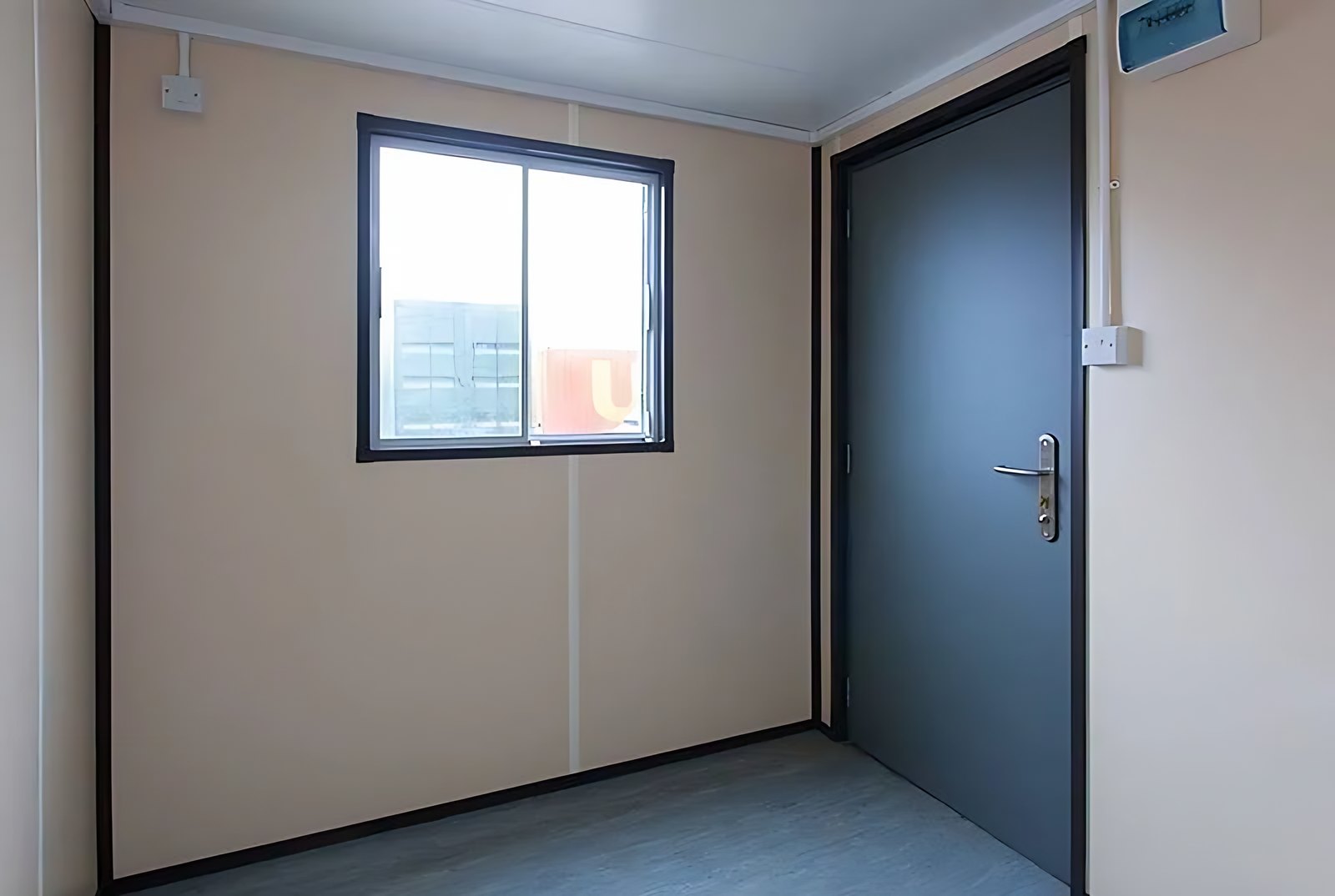 20ft Steel Office Container – Open Workspace Shell – empty office interior with window and closed steel door