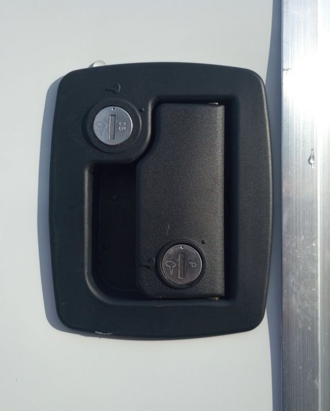 2024 Mission Trailers 24 ft Deckover – Galvanized Package – Close-up of a black recessed door handle with two key locks