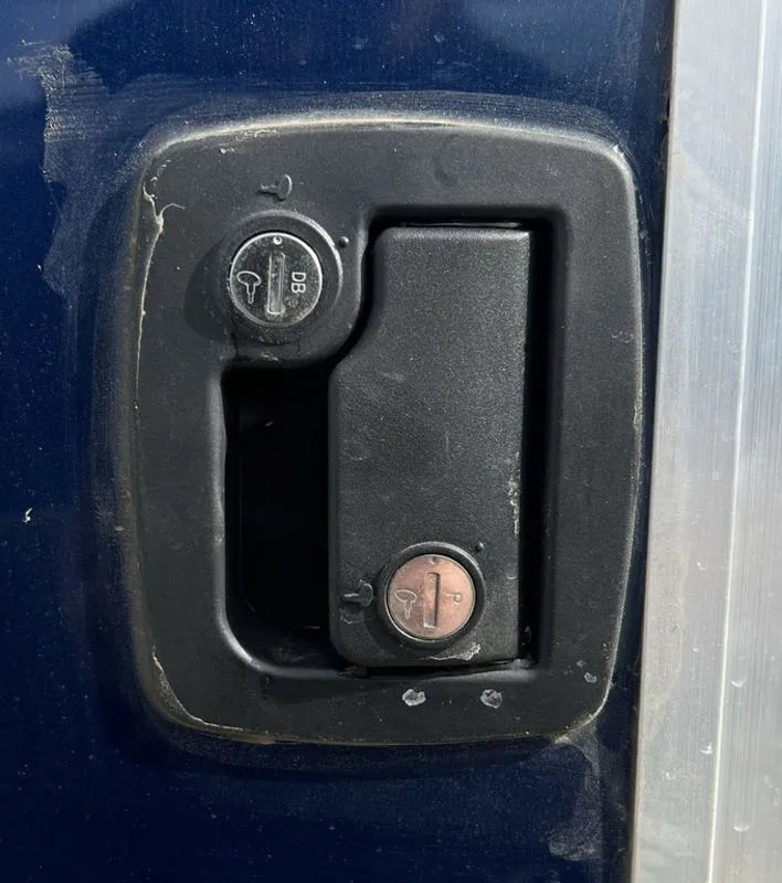 2023 High Country 14 ft Trailer – Blue, Drive-Through – Close-up of the black locking flush-mount handle on the side entry door