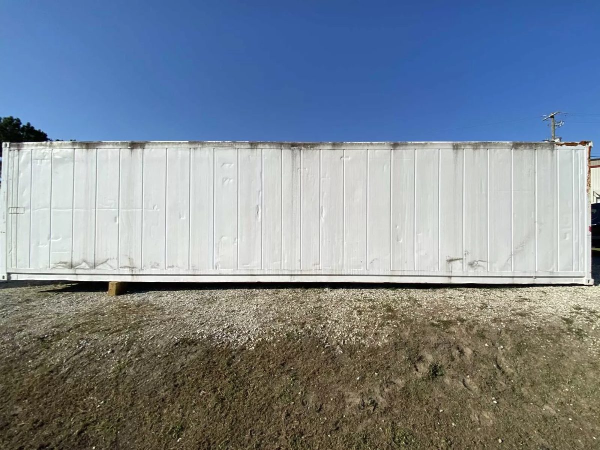 40ft High Cube Insulated Container – Lighting and Electrical – Side view of weathered white container on gravel