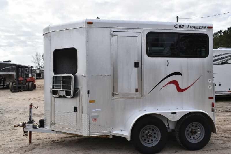2001 CM Odyssey 2 Horse Trailer – Aluminum Floor – Side profile of the horse trailer showcasing the dual axles and graphics