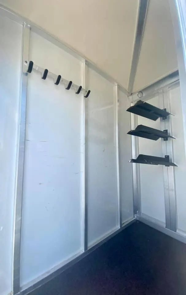 2011 Cimarron 3 Horse Bumper Pull – Insulated Roof – Tack room walls featuring a row of bridle hooks
