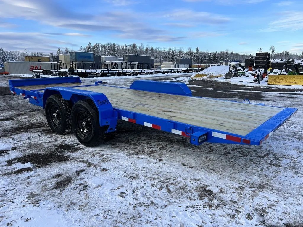 2024 Rice Trailers 20 ft Tilt Trailer – Spare Mount – Rear three-quarter view of the blue flatbed trailer with dual axles and wood deck