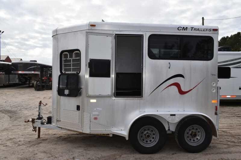 2001 CM Odyssey 2 Horse Trailer – Aluminum Floor – Full side view of the silver horse trailer with red and black graphics