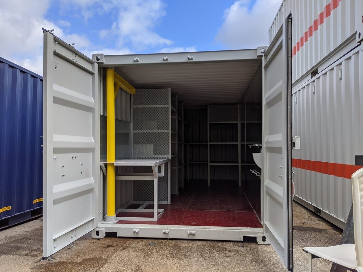 20ft Custom Workshop Container – Built-In Steel Shelving – open container doors revealing workshop shelving and workbench
