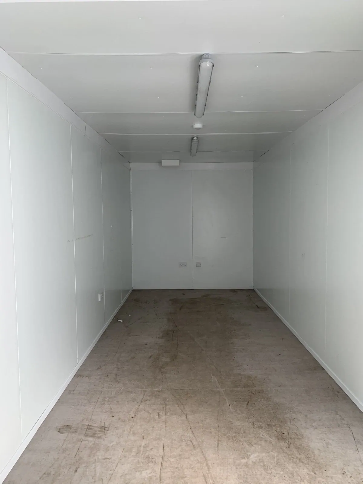 20ft Insulated Storage Container – Steel Lock Boxes – empty insulated interior with white panels and ceiling lights