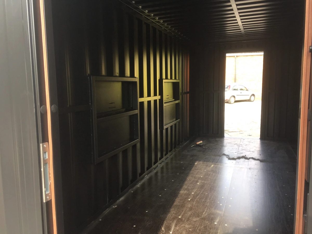 20ft Converted Shipping Container – Serving Hatches and Roof Deck – empty container interior with closed hatches and open doorway
