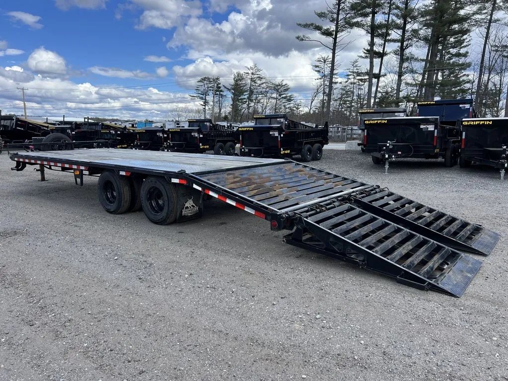 2022 Iron Bull Trailers Equipment Trailer – Rampage Ramps – Rear perspective of the deckover trailer with ramps down and other trailers behind