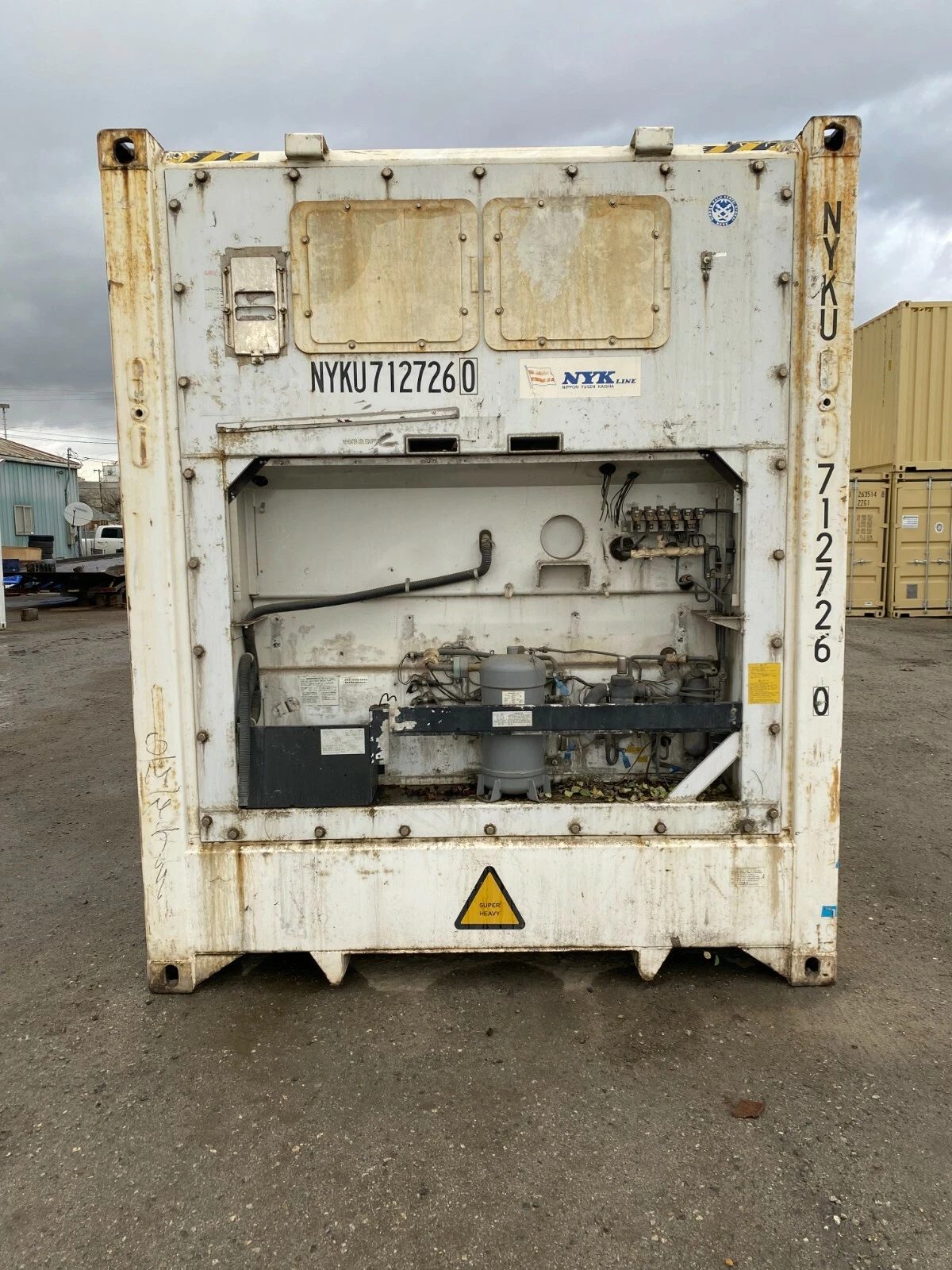 40ft Used Reefer Container – Non-Working Insulated Storage – front end of weathered refrigerated container with exposed machinery