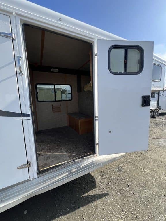 2020 Trails West Sierra 4 Horse Gooseneck – Comfort Package – Open entrance door leading into the carpeted living quarters