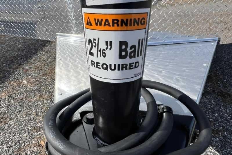 2024 Shadow 2 Horse Bumper Pull Trailer – Aluminum, Dressing Room – Close-up of the trailer hitch coupler with a warning sticker