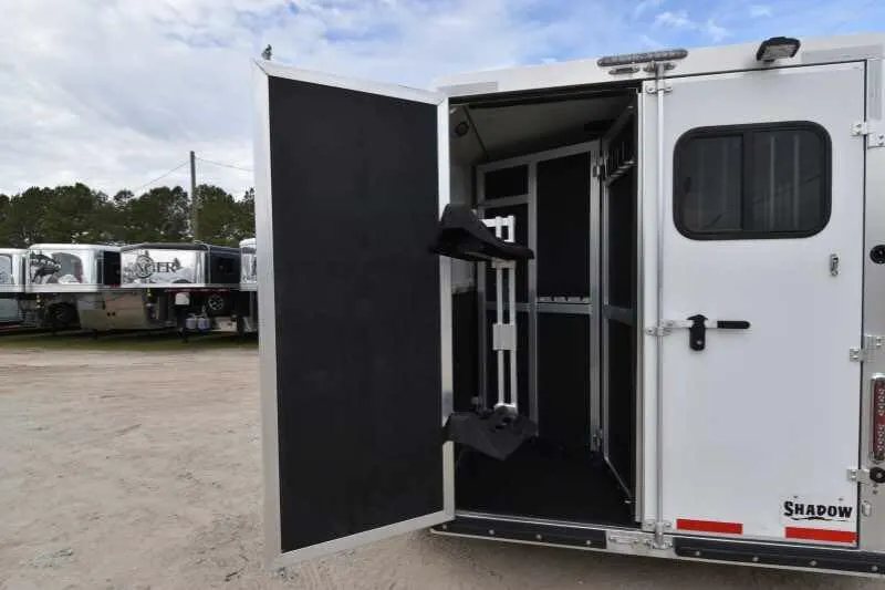2016 Shadow 2HBP 2 Horse Bumper Pull Trailer – Aluminum – Partial view of rear door open showing internal tack equipment