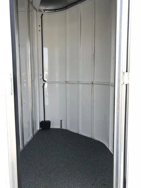 2010 Merhow 2 Horse Slant Trailer – Insulated Roof, Escape Door – Clean interior view of the front dressing or tack room compartment