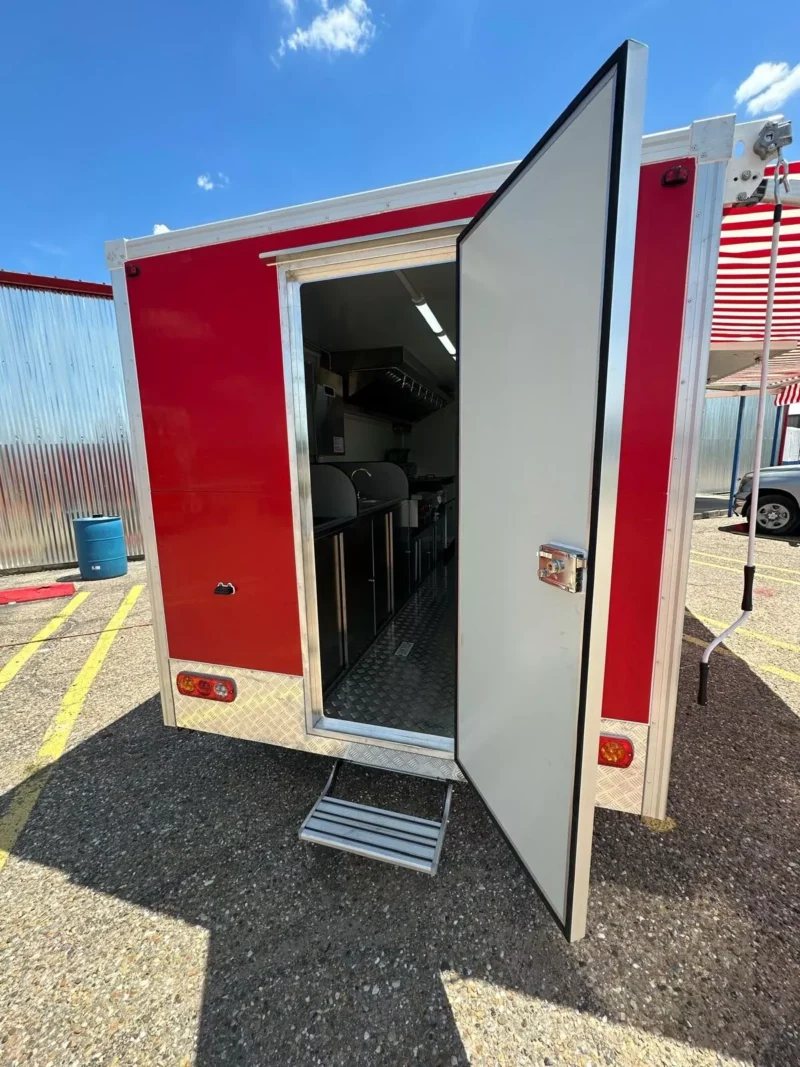 14 ft Food Trailer – Red Finish – Rear entry door of the red trailer open showing the interior floor