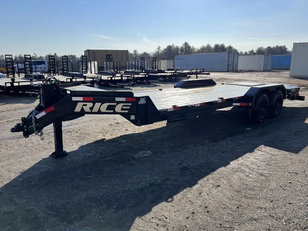 2024 Rice Trailers 18 ft Equipment Trailer – Hydraulic Jack – Three-quarter exterior view of a black flatbed equipment trailer on a gravel lot
