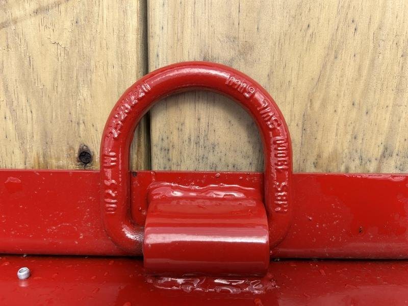 2024 Rice Trailers 22 ft Tilt Deck – Red, Toolbox – Close-up of a red heavy-duty D-ring tie-down point on the deck