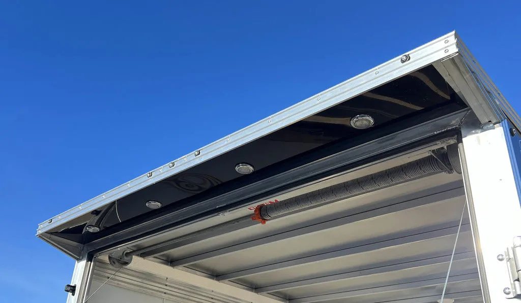 2024 Sno Pro 22 ft Snowmobile Trailer – Extra Height – Rear exterior canopy over the ramp door with integrated loading lights