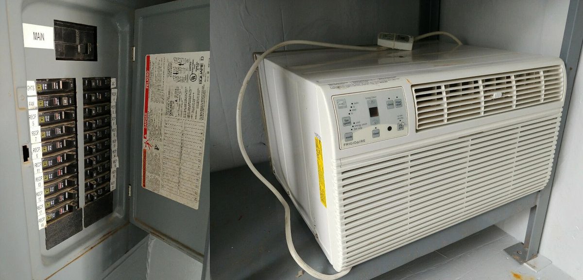 40ft High Cube Container Office – Storage Racking, Side Access – wall-mounted air conditioner beside open electrical breaker panel