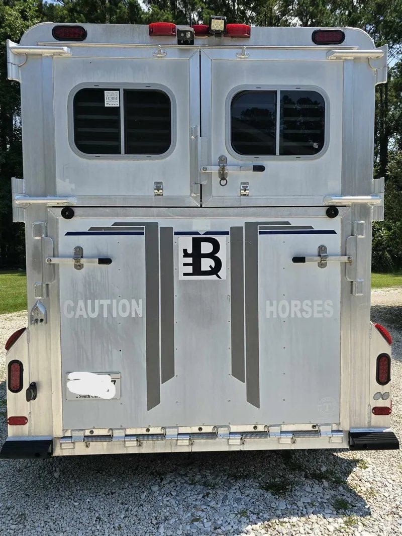 2000 C&C 2 Horse Gooseneck Trailer – Aluminum, Dressing Room – Direct rear exterior view of the trailer showing closed doors and decals