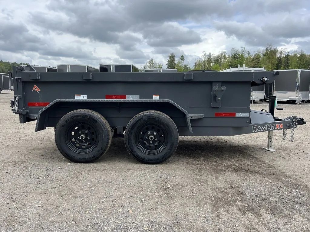 2024 RawMaxx 10 ft Dump Trailer – Shadow Grey – Full right side profile of the grey dump trailer against a cloudy sky