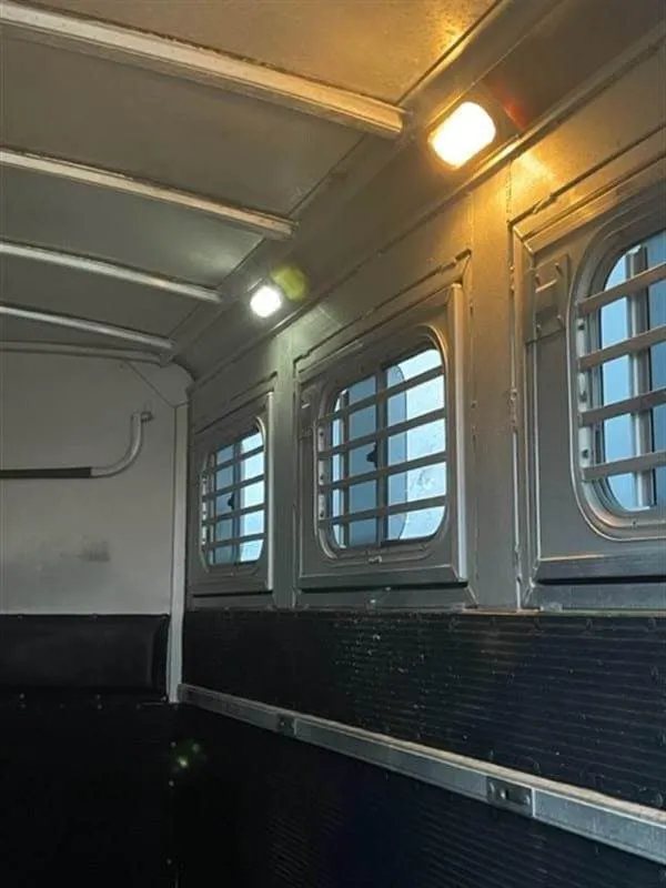 1999 Elite Custom 3 Horse Trailer – Rotating Saddle Rack – Close-up of interior ceiling lights above the horse stall windows
