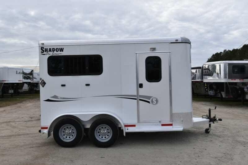 2018 Lakota 2HBPST 2 Horse Trailer – Dressing Room – Side view of a white trailer in a lot with other units visible