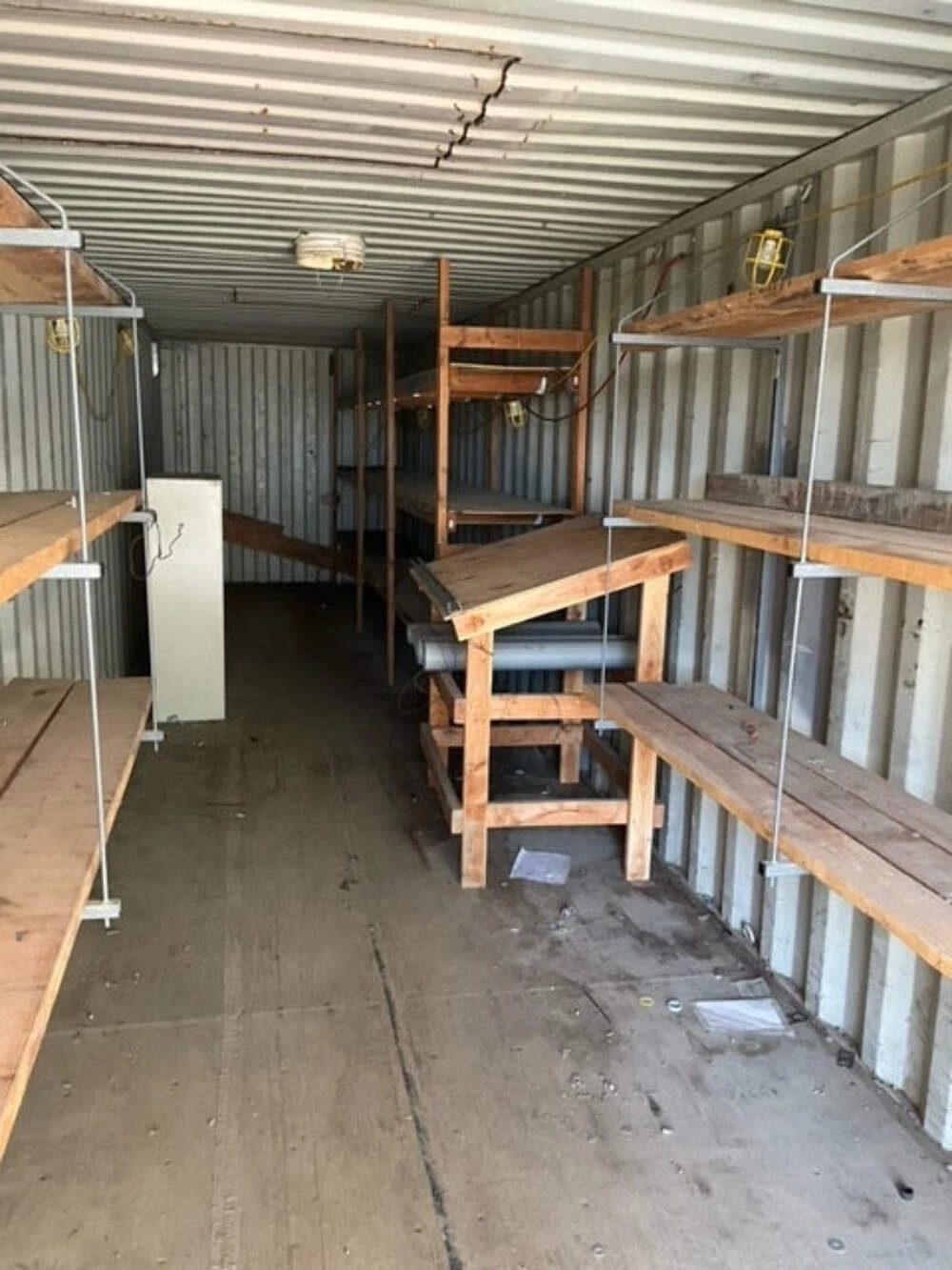 40ft Used Shipping Container – Double Doors at Both Ends – container interior with wooden shelving and scattered debris