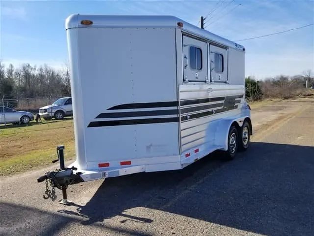2001 4 Star 2 Horse Bumper Pull Trailer – Slant Load – Front three-quarter view from the street side showing the hitch and side windows