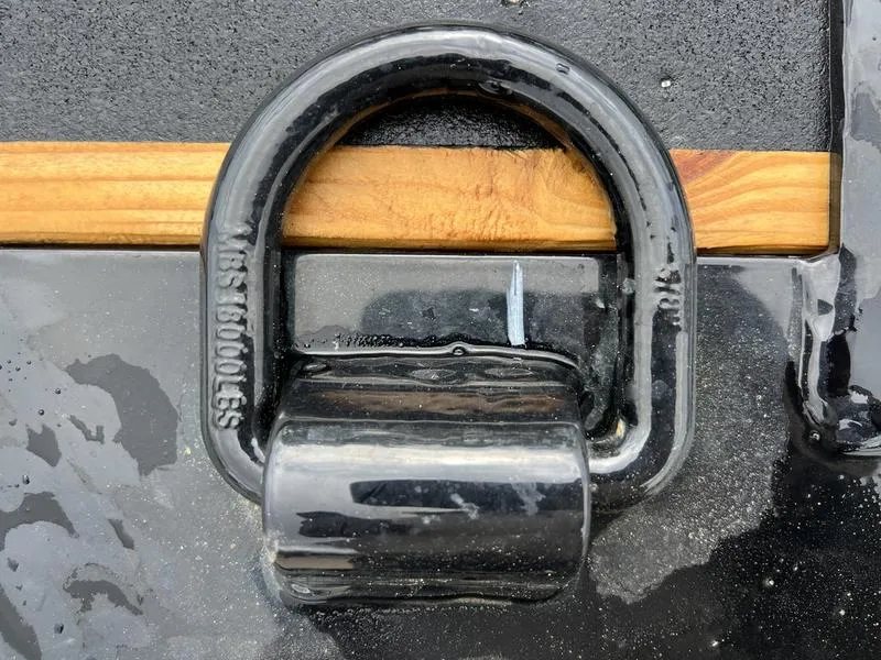 2024 Diamond C 24 ft Tilt Trailer – Spare Mount – Extreme close-up of a heavy-duty metal D-ring tie down point