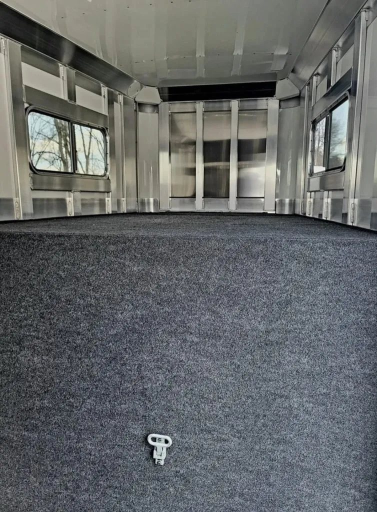 2023 4 Star 23 ft Horse Trailer – 2+1 Gooseneck – Interior of the front gooseneck compartment with gray carpeting and windows