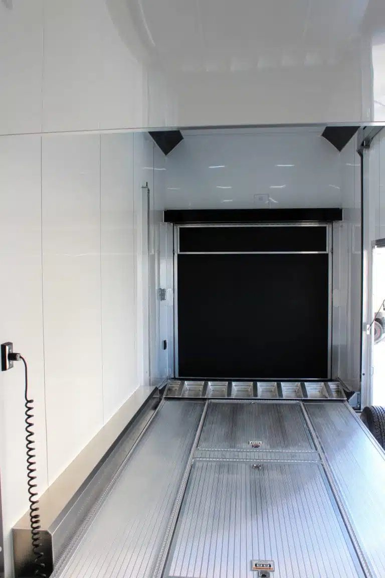 2026 ATC 26 ft Stacker Trailer – Tiltable Lift – Clean white interior of a stacker trailer showing the rear ramp and lift