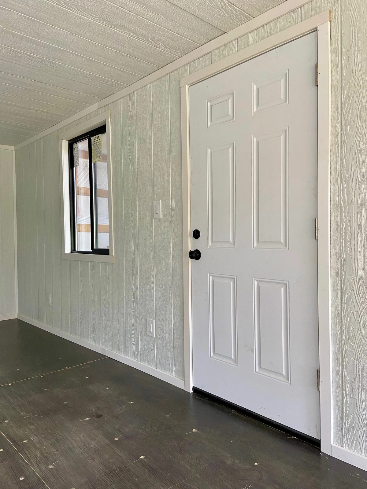 20ft Modular Container Office – LED Lighting, Two Windows – Interior entry door beside window with white paneled walls