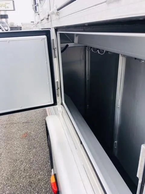 2018 Platinum Coach 3 Horse Bumper Pull – Rear Tack – Close up view of the open side storage compartment