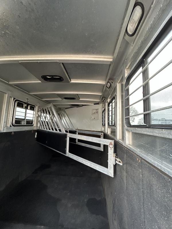 2002 Silverado 3 Horse Gooseneck Trailer – Wood Interior – Inside the horse transport area showing metal dividers and rubber floor mats
