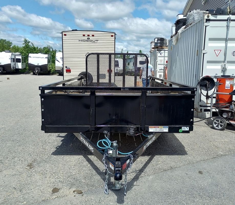 2024 PJ Trailers 14 ft Utility – Solid Metal Sides – Front view showing the hitch, safety chains, and solid front wall of the trailer