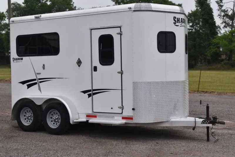 2013 Shadow 2HSL 2 Horse Trailer – Aluminum, Dressing Room – Three-quarter front-right view of the white horse trailer showing the side entry door