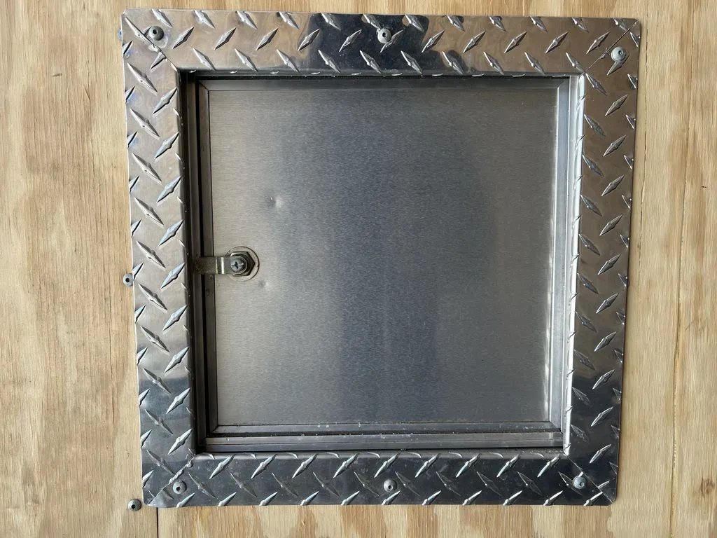 2008 Sno Pro 4-Place Snowmobile Trailer – Black Aluminum – Small metal access door with diamond plate trim on wood panel