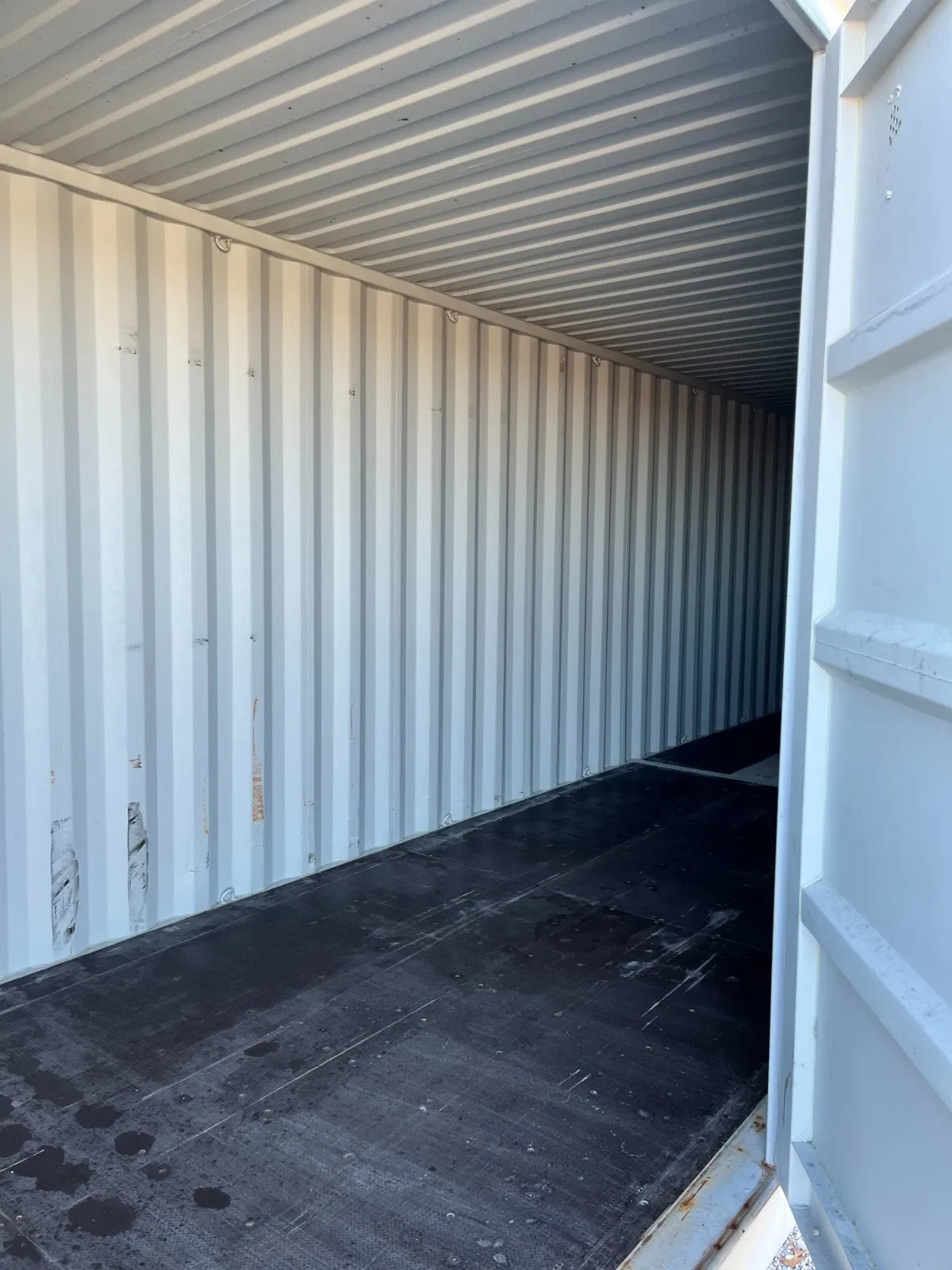 40ft High Cube Shipping Container – Side and End Doors – empty container interior with corrugated walls and scuffed dark floor