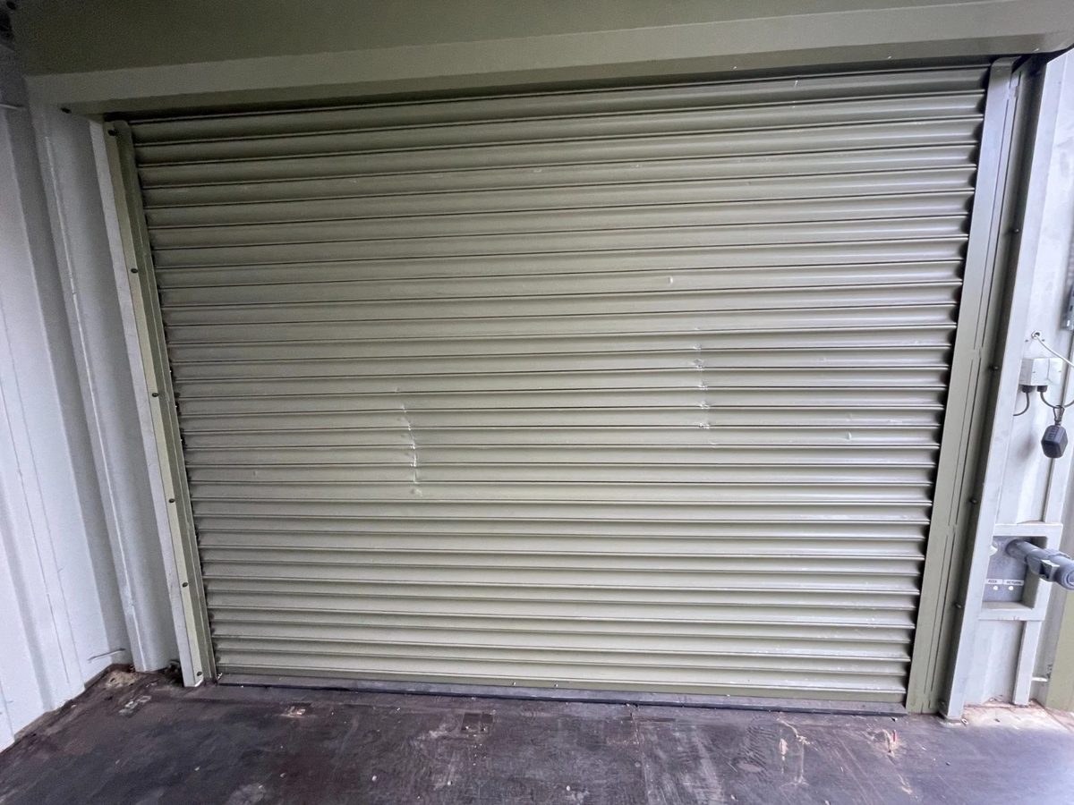 13ft Used Shipping Container – Lock Box Storage – closed roller shutter door viewed from inside container