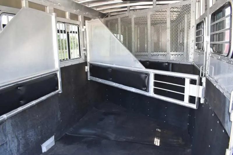2006 Adam 7302 3 Horse Trailer – Aluminum, Dressing Room – View of the horse stalls with metal dividers and wall padding