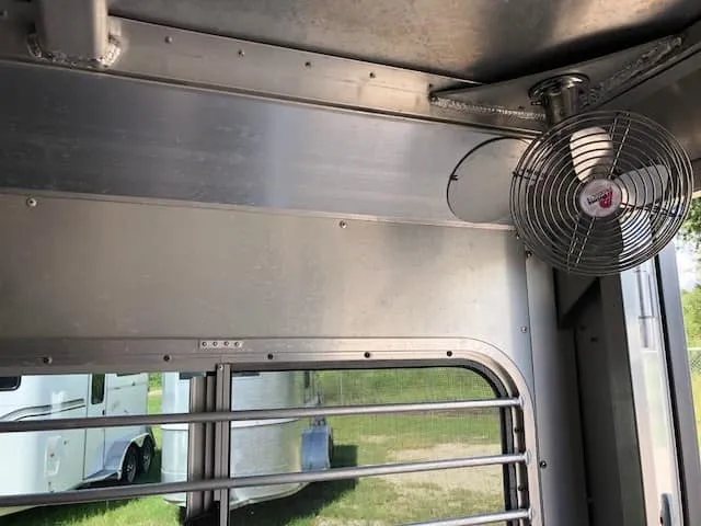 2004 4 Star 2 Horse Gooseneck Trailer – Slant Load, White – Close-up of a metal circulation fan mounted inside the horse stall area