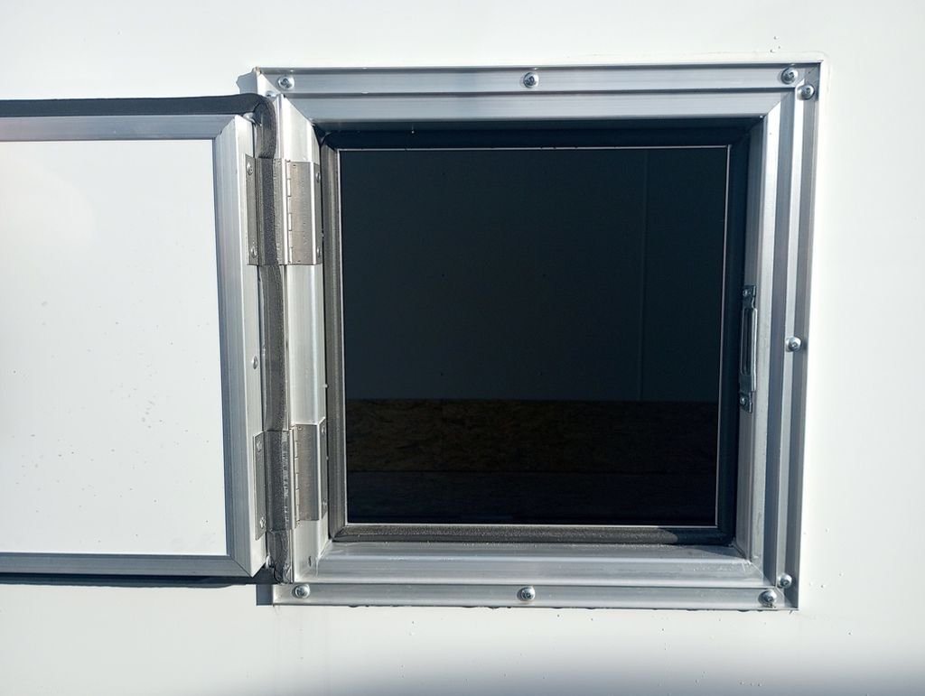 2024 Mission Trailers 24 ft Deckover – Galvanized Package – View of an open small square access door on the side of the trailer